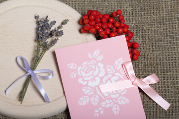 Greeting card and bunch of mountain ash. Near a bouquet of lavender. Autumn still life.