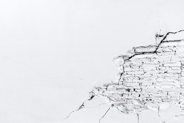 White cement wall with cracked brick texture
