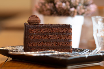 Close up of Chocolate cake sliced on wooden desk