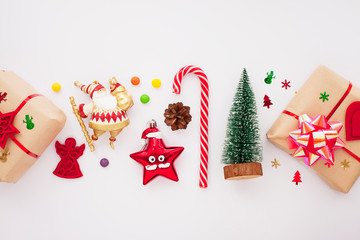 Christmas composition. Beautiful toys, gifts and candy on the white background. New year background. Top view. Close up. Space for a text.