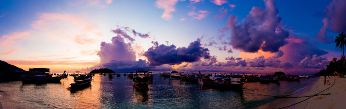 Panorama view of sunrise morning beach with boat sky cloud