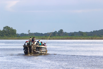 India, Assam state, Brahmaputra river, 21.07.2018. The ferry transports people and cars on the ...