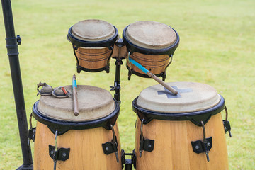 Fototapeta premium Close up image of wooden ethnic drums isolated on green background. Drums of Thailand style.