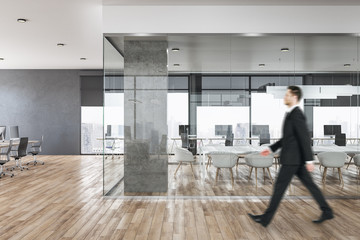 Businessman in contemporary concrete office interior