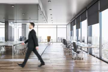 Businessman in modern concrete office interior