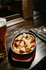 fried meat with vegetables in cheese sauce