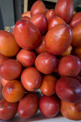 Fresh organic tamarillo fruit, known as tomate de árbol (tree tomato) at a public  market in Ecuador.  Nutritious healthy vegan food.
