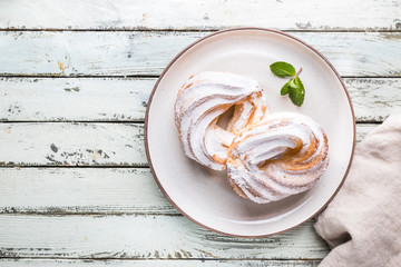 Custard or cottage cheese cakes rings on a white plate, top view