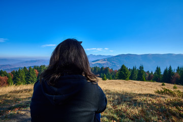 woman looking at autumn landscape view