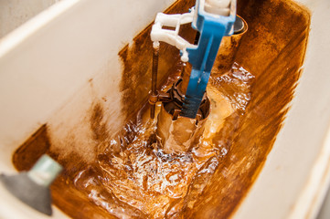 Whirlpool in the toilet storage tank. Actuation of the float valve. Scale on the walls of hard...