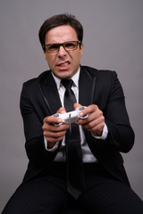 Portrait of Persian businessman in suit playing games