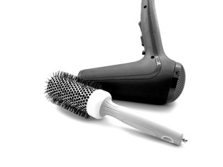 Black hair dryer with a white big comb isolated on a white background. Modern hair dryer with...
