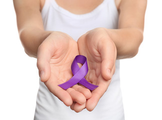 Woman holding purple ribbon on white background, closeup. Domestic violence awareness