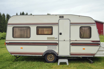 Camper van standing at field at finnish countryside , travel concept, alternative life, hippie lifestyle