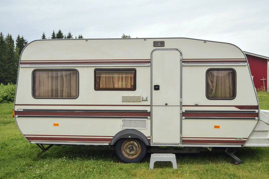 Camper van standing at field at finnish countryside , travel concept, alternative life, hippie lifestyle - Powered by Adobe