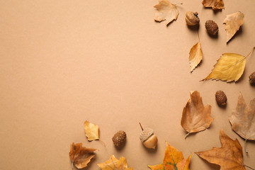 Flat lay composition with autumn leaves on brown background. Space for text