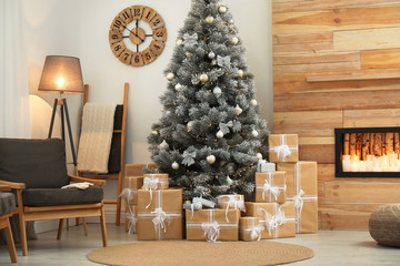 Stylish room interior with beautiful Christmas tree and gift boxes