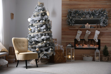 Festive interior with beautiful Christmas tree and gifts