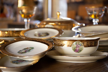 Finely decorated festive vintage dishes for a golden christmas table