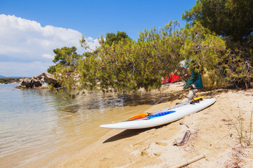Fototapeta na wymiar Kayak with paddle at lonely sand beach