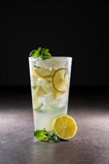 Fresh mojito cocktail on black separated background