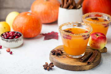 Spicy hot pumpkin punch or sangria in a glass with apple, cinnamon, anise. Halloween and Thanksgiving. Traditional autumn, winter drinks and cocktails