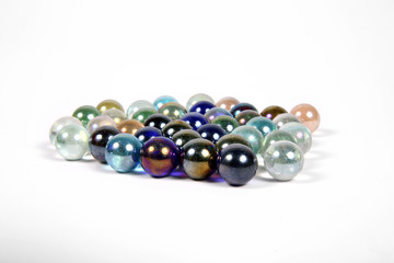 Colored glass bullets on white ground isolated-