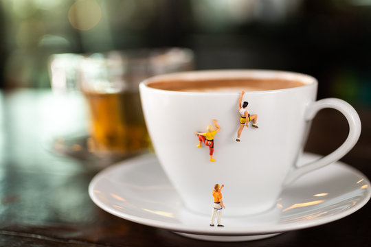 Miniature people : Coffee cup , image use for charge your energy in the morning