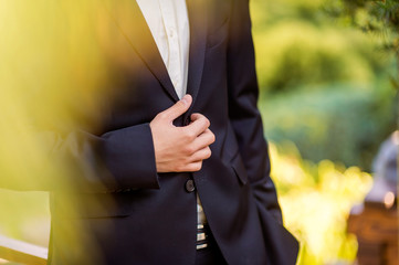 Businessman wears a jacket,male hands closeup,groom getting ready in the morning before wedding...