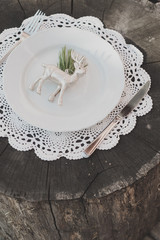 Christmas, decor, fir branches, cones, rustic, vintage, rustic style, Scandinavian style, knitted napkins, white plates, silver cutlery, light background, white, red, flowers, shiny deer.