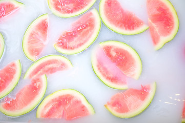 Turbid soapy water in bath with slices of watermelon. top view in full frame. The largest berry. spa with milk in the bath for rejuvenation..