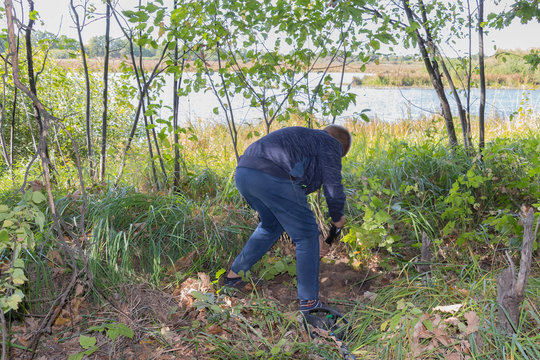 A Child With A Metal Detector Is Looking For Treasures