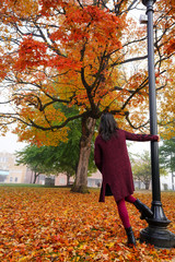 Portrait of woman standing along a pole at National Historic District in Harrison, Arkansas along...
