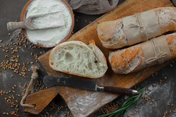 Bread in a composition with kitchen accessories on an old background