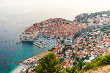 Naklejka premium Dubrovnik, Croatia - July, 2019: View from the top of the mountain of Srdj to the old part of the city in the fortress in Dubrovnik, Croatia.