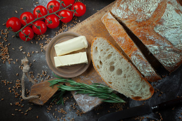 Bread in a composition with kitchen accessories on an old background