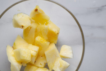 Pineapple in the bowl on marble background