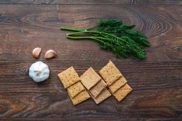 wheat crackers shooted with different  vegetables,groats,honey,seeds,salt on different surfaces