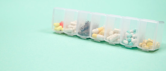 Assorted medical drugs and syringe on blue background