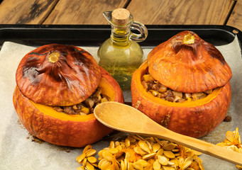 baked pumpkin in the oven with raisins and apples