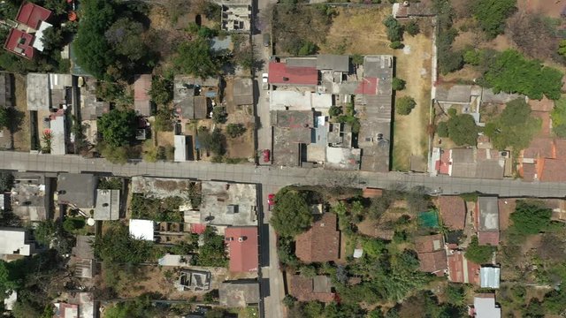 Aerial drone vertical view of the streets of a colonial colorful town in a modest neighborhood