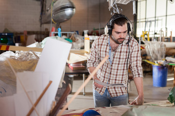 Man looking at paper drawings