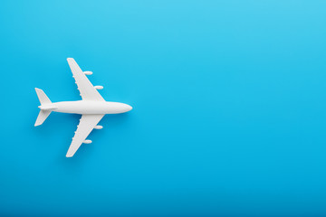 Passenger Model airplane on a blue background. Free space for text.