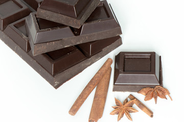 Pieces of Chocolate and cinnamon isolated on white background