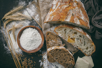 Bread in a composition with kitchen accessories on an old background