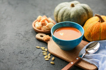  Vegetarian autumn pumpkin cream soup with seeds. Seasonal autumn food - pumpkin soup with thyme. Pumpkin soup with herbs, cream, breadcrumbs and parmesan, served in a bowl, top view. Place for text