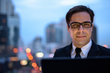 Handsome Persian businessman against view of the city