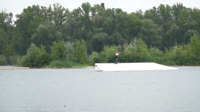 Stunt, rail slide with a spin, wakeboarding championship, aerial shot