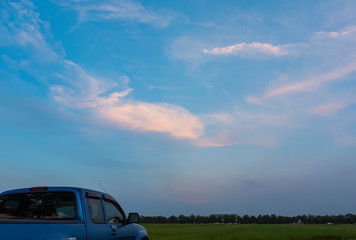 Fototapeta na wymiar Blue pickup truck at sunset sky