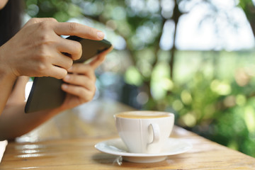 Asian woman take a photo of hot latte coffee